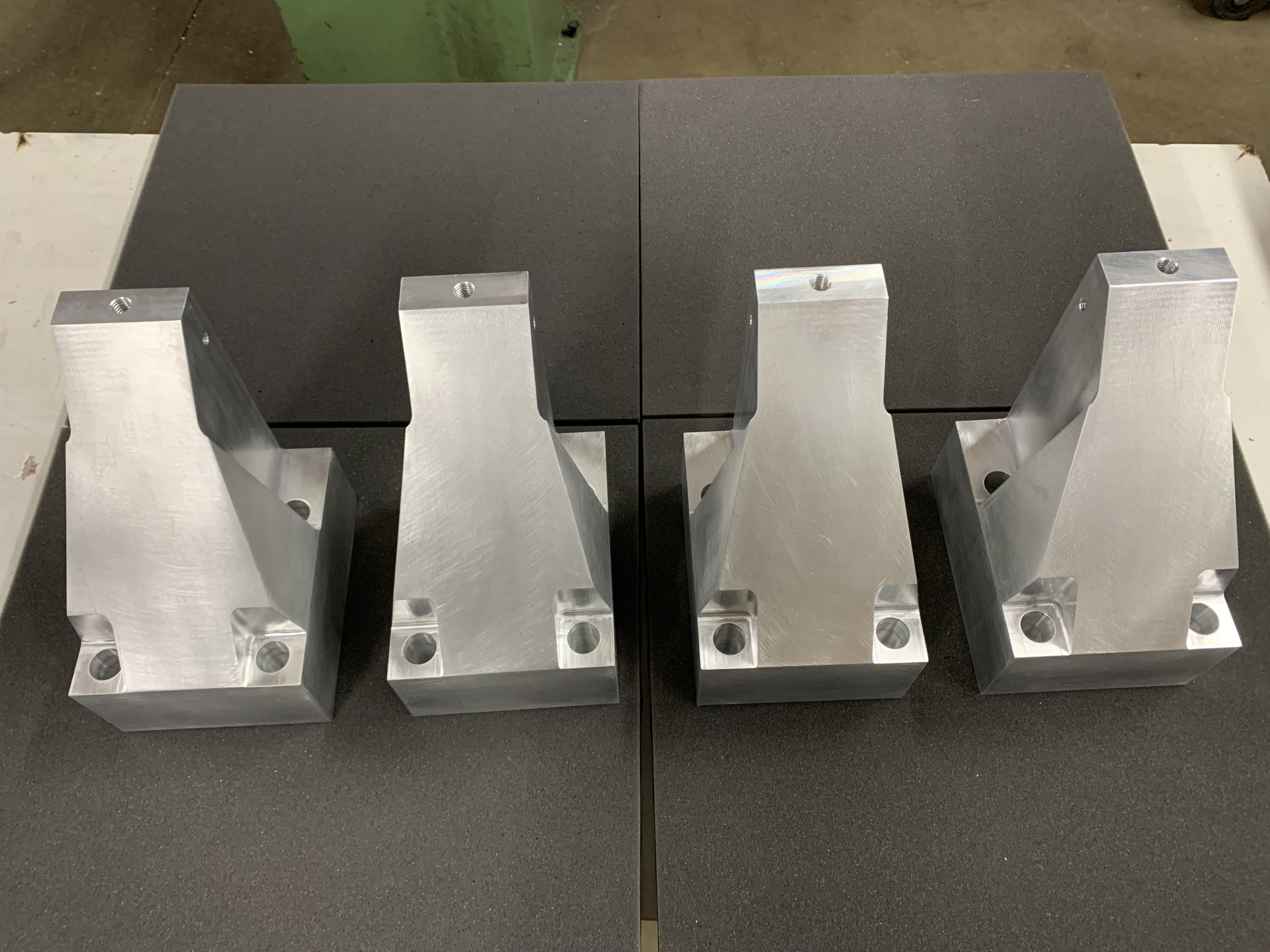 Four aluminum trapezoidal components - CNC machined
