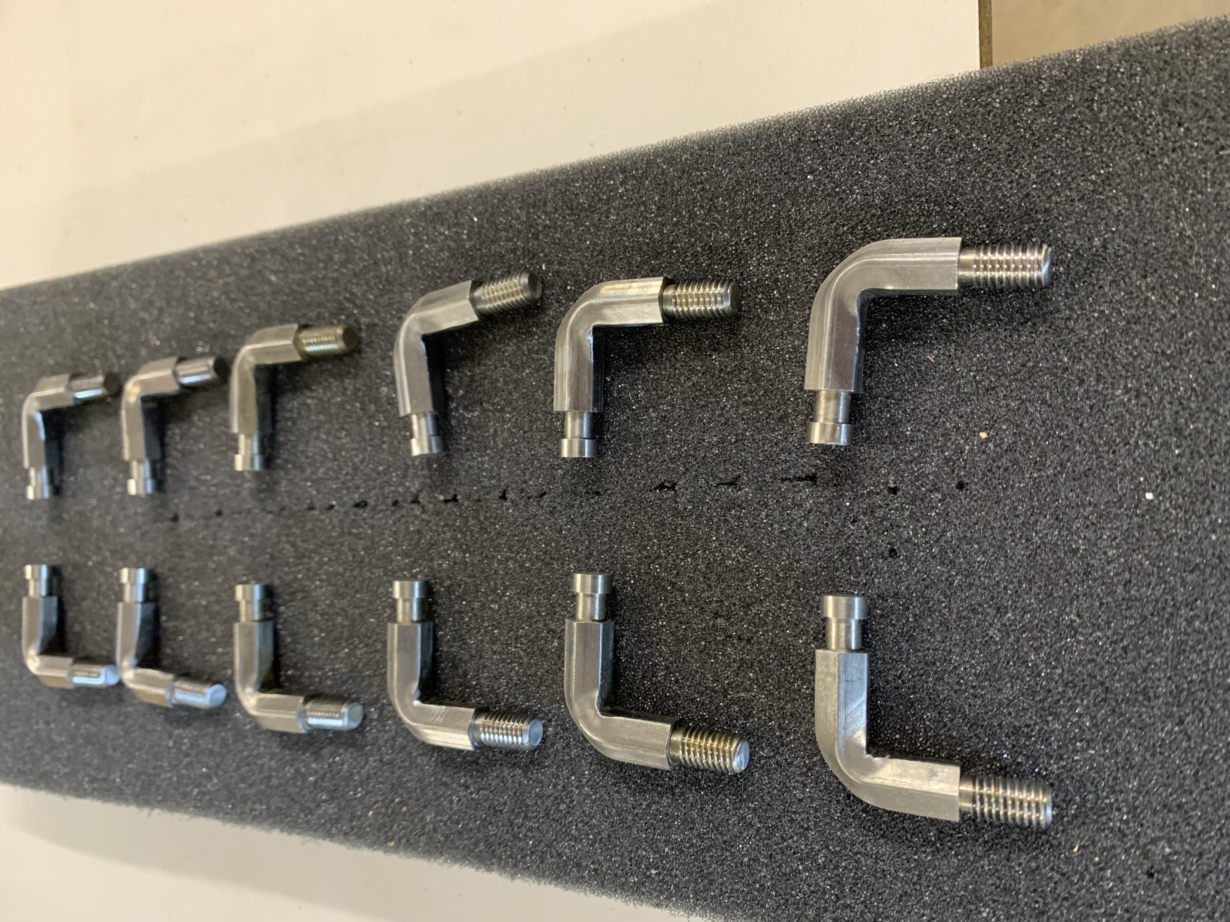 CNC machined L-shaped brackets on foam