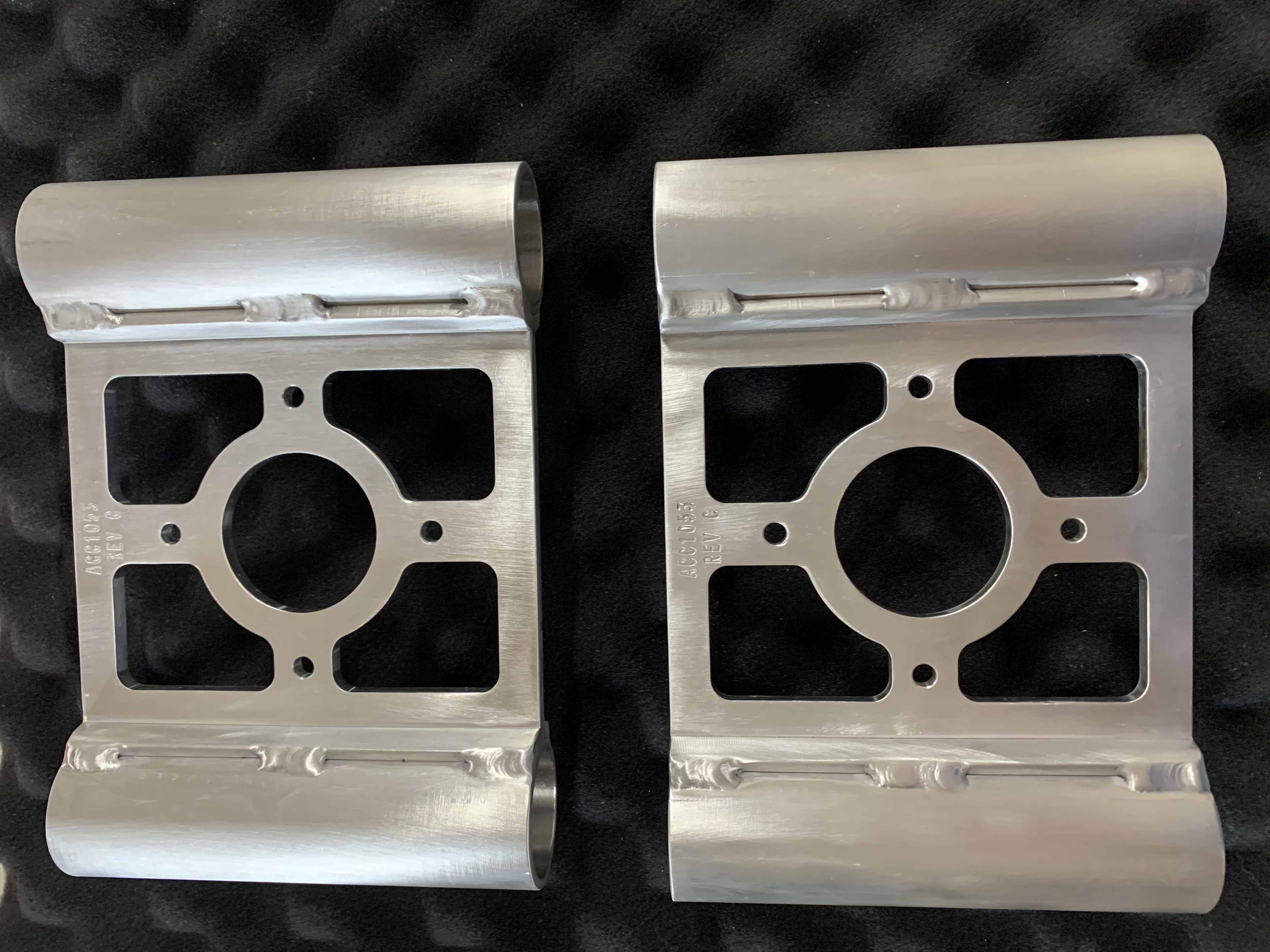 TIG welded metallic brackets with engraved designs